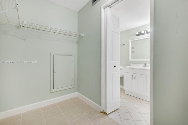 1111 Adams Ave Unit 1111B, Homestead, FL 33034 - laundry area featuring light tile patterned floors and baseboards