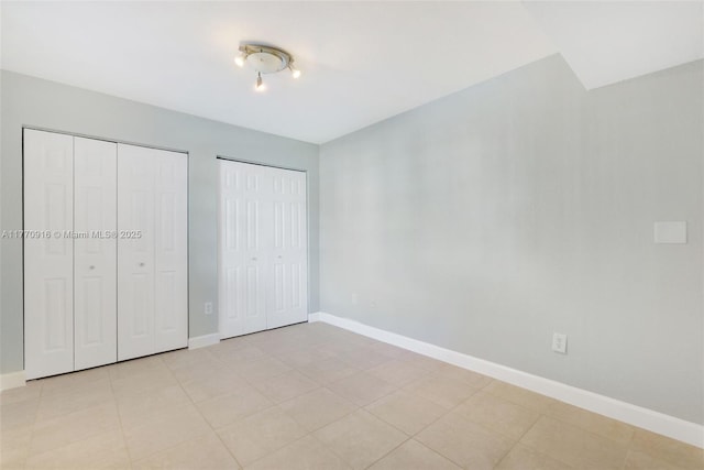 1111 Adams Ave Unit 1111B, Homestead, FL 33034 - unfurnished bedroom featuring baseboards and multiple closets