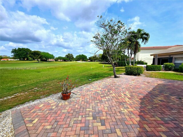 5645 Lakeview Mews Dr, Boynton Beach, FL 33437 - rear view of house with stucco siding, a patio, a sunroom, and a tile roof