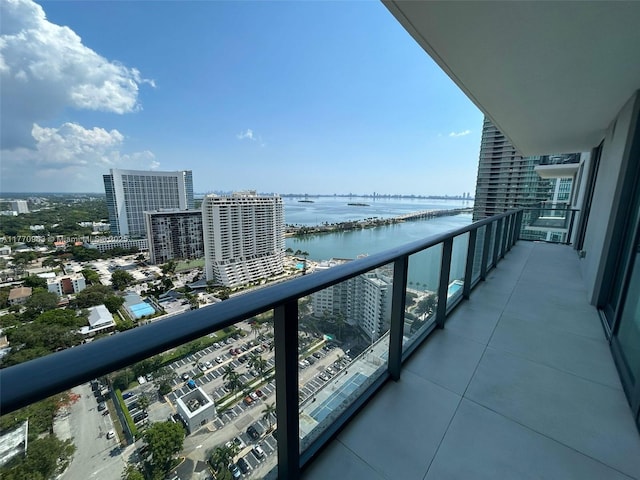 balcony featuring a water view and a view of city