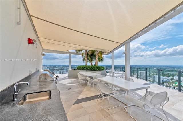 view of patio featuring exterior kitchen and a sink