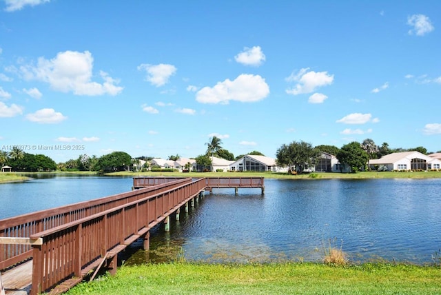 view of dock with a residential view and a water view