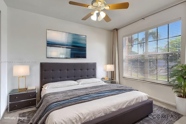 bedroom featuring baseboards, ceiling fan, and carpet flooring