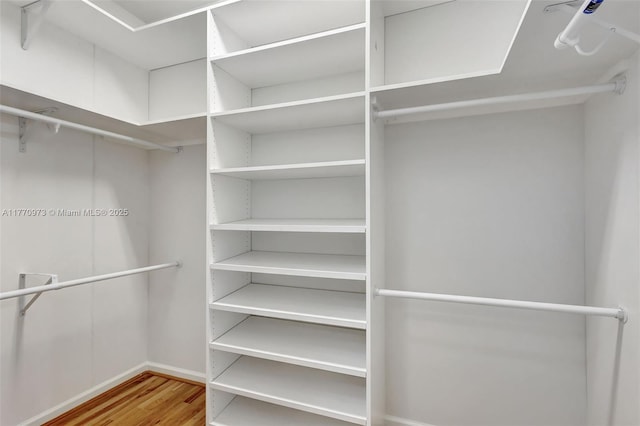 spacious closet with wood finished floors