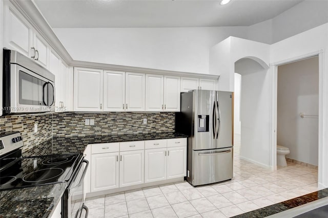 kitchen featuring white cabinets, appliances with stainless steel finishes, and decorative backsplash