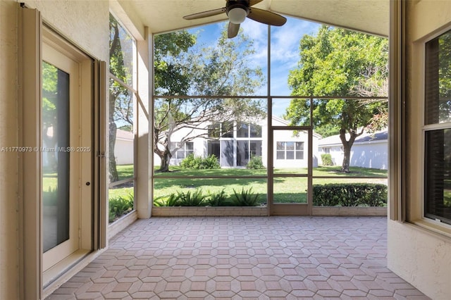 unfurnished sunroom with a ceiling fan