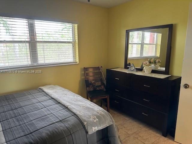 bedroom with light tile patterned floors