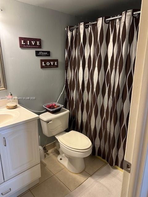 bathroom with tile patterned floors, vanity, and toilet