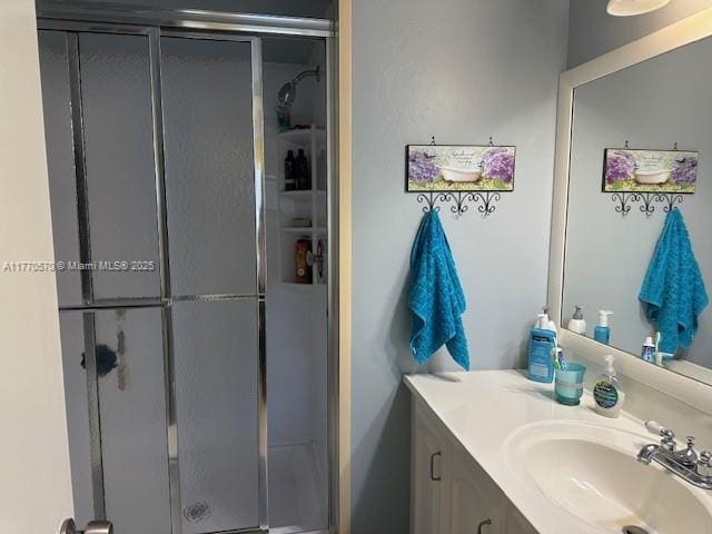 bathroom featuring vanity and a shower stall