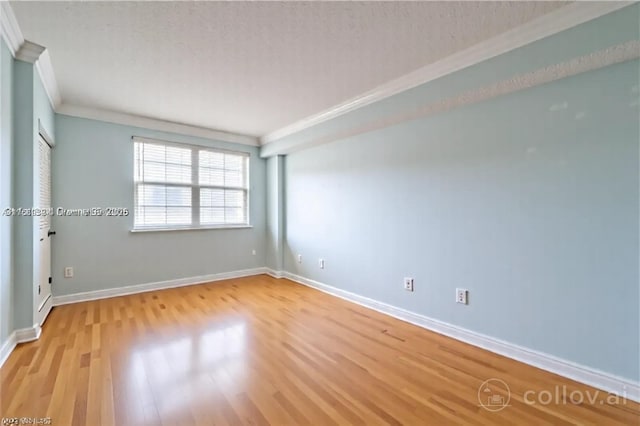 10140 W Bay Harbor Dr Unit 502B, Bay Harbor Islands, FL 33154 - spare room featuring ornamental molding and light wood finished floors