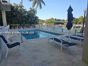 10140 W Bay Harbor Dr Unit 502B, Bay Harbor Islands, FL 33154 - community pool featuring a patio area and a water view