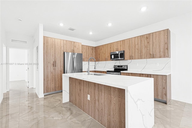 kitchen featuring visible vents, marble finish floor, modern cabinets, stainless steel appliances, and a sink