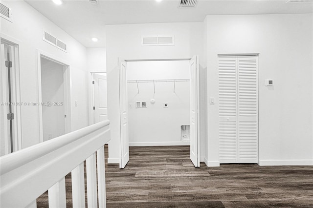 hall with dark wood-style floors, baseboards, and visible vents