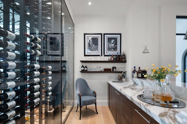 3918 Island Estates Dr, Aventura, FL 33160 - wine area with light wood-style flooring, baseboards, and a sink