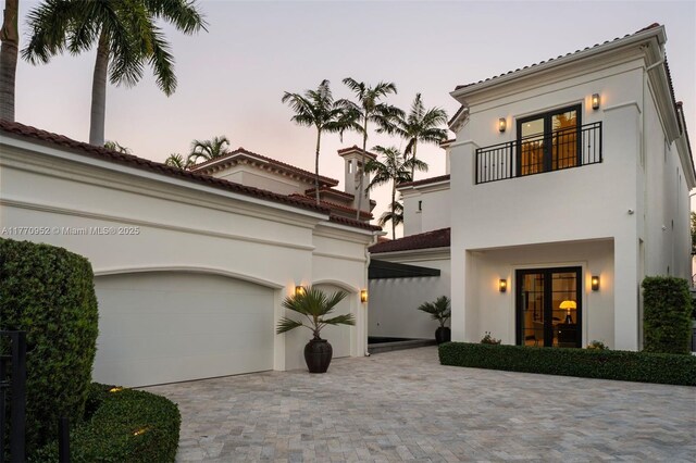 3918 Island Estates Dr, Aventura, FL 33160 - mediterranean / spanish home with an attached garage, stucco siding, decorative driveway, and a balcony