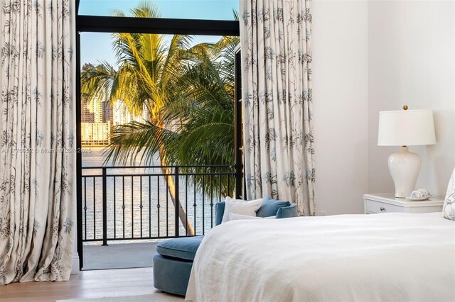 3918 Island Estates Dr, Aventura, FL 33160 - bedroom with multiple windows and wood finished floors