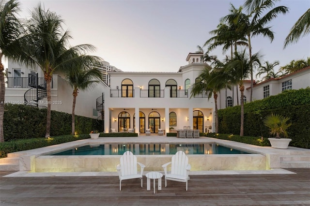 3918 Island Estates Dr, Aventura, FL 33160 - back of property with an outdoor pool, a patio area, stucco siding, and a balcony
