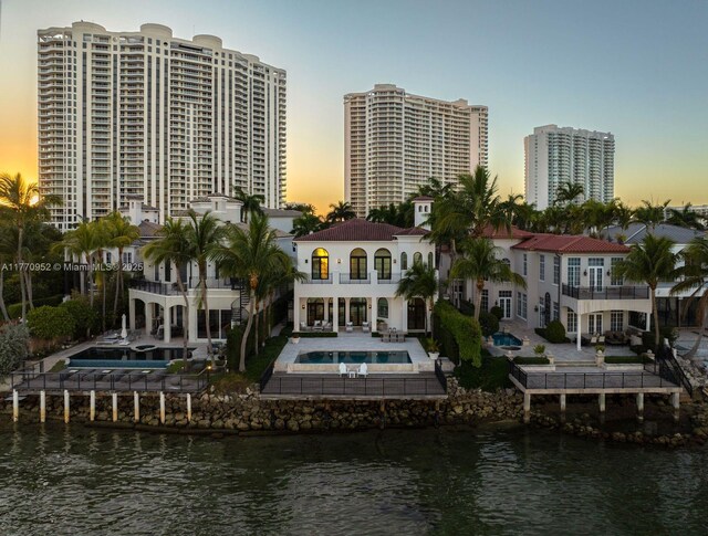 3918 Island Estates Dr, Aventura, FL 33160 - rear view of property with a water view, a patio, fence, a balcony, and an outdoor pool