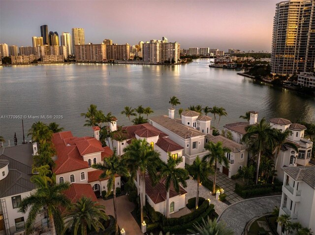 3918 Island Estates Dr, Aventura, FL 33160 - aerial view at dusk featuring a view of city and a water view
