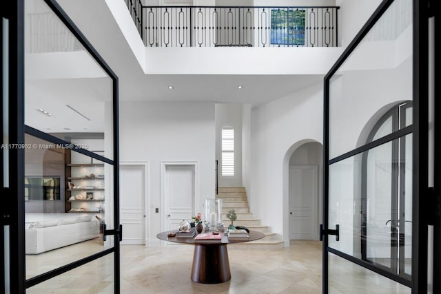 3918 Island Estates Dr, Aventura, FL 33160 - foyer with arched walkways, a high ceiling, and stairs