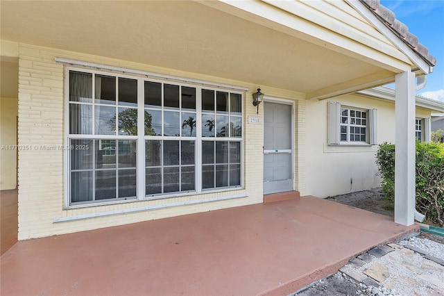 property entrance featuring brick siding