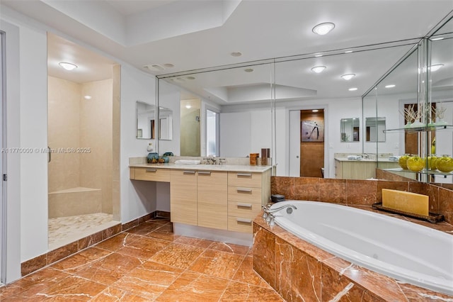 full bath featuring a bath, baseboards, tiled shower, and vanity