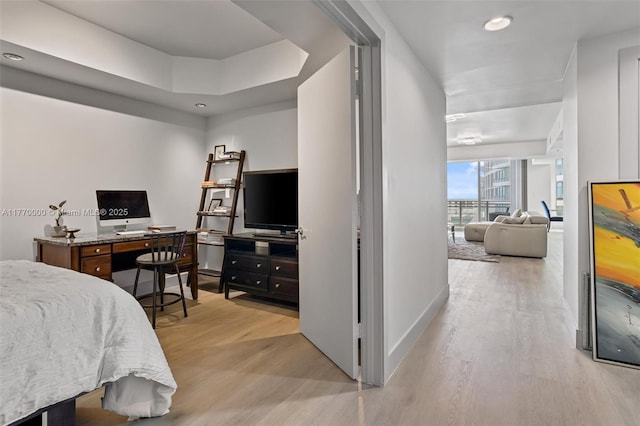 bedroom with baseboards, wood finished floors, and recessed lighting