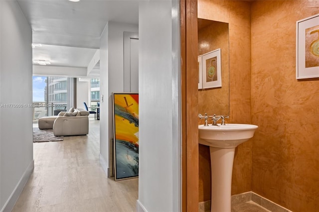 bathroom featuring baseboards and wood finished floors