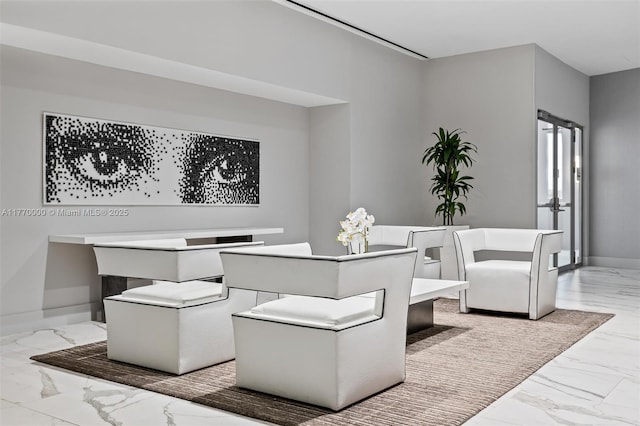 dining area featuring marble finish floor and baseboards