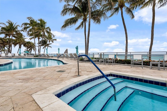 pool featuring a patio and a hot tub