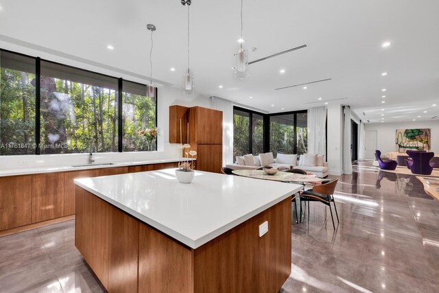3232 Emathla St, Miami, FL 33133 - kitchen featuring modern cabinets, brown cabinetry, a center island, plenty of natural light, and recessed lighting