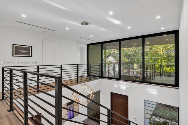 3232 Emathla St, Miami, FL 33133 - hallway with an upstairs landing, recessed lighting, and wood finished floors