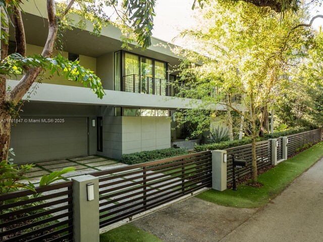 3232 Emathla St, Miami, FL 33133 - view of front facade with a balcony, stucco siding, and an attached garage