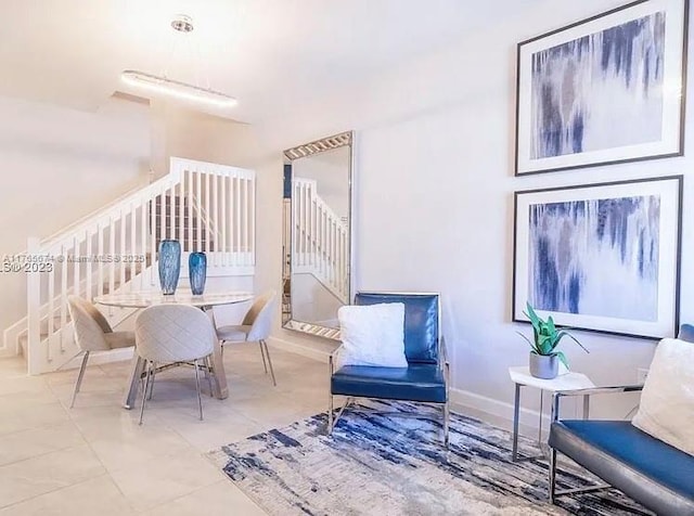 interior space with tile patterned flooring, baseboards, and stairs