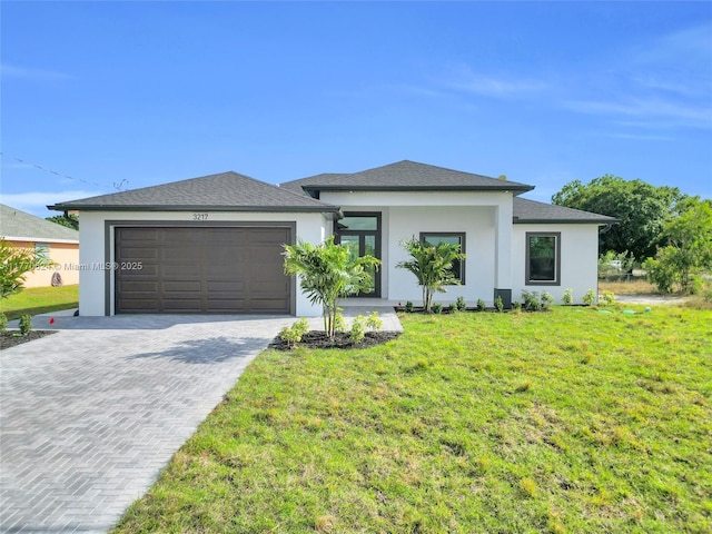 3217 SW 23rd St, Lehigh Acres, FL 33976 - prairie-style home featuring stucco siding, driveway, a garage, and a front yard