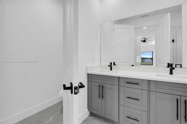 3217 SW 23rd St, Lehigh Acres, FL 33976 - full bathroom featuring marble finish floor, a sink, double vanity, and baseboards