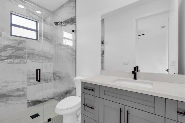 3217 SW 23rd St, Lehigh Acres, FL 33976 - bathroom featuring toilet, vanity, a marble finish shower, and visible vents