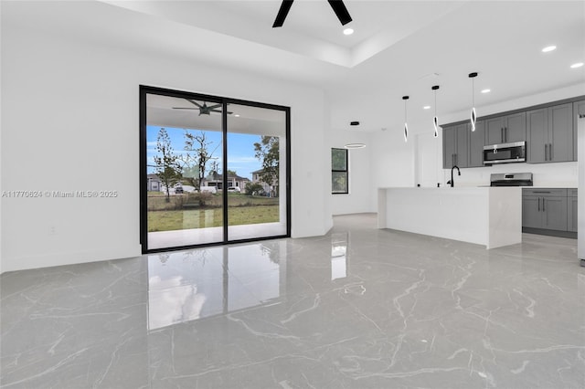 3217 SW 23rd St, Lehigh Acres, FL 33976 - kitchen featuring a tray ceiling, recessed lighting, gray cabinets, stainless steel appliances, and ceiling fan