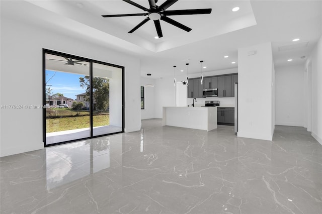 3217 SW 23rd St, Lehigh Acres, FL 33976 - unfurnished living room featuring recessed lighting, a tray ceiling, baseboards, and ceiling fan