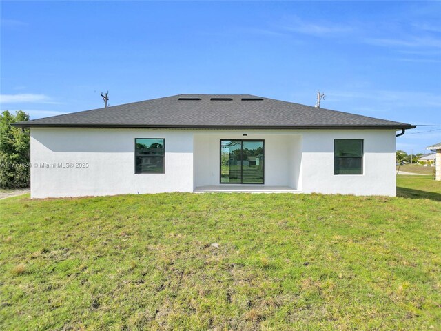 3217 SW 23rd St, Lehigh Acres, FL 33976 - rear view of property featuring a lawn, roof with shingles, and stucco siding