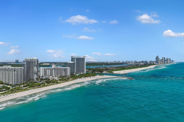 bird's eye view featuring a water view, a city view, and a beach view