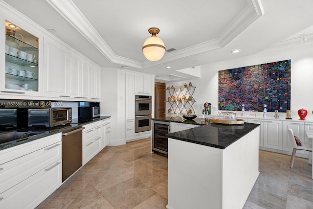 kitchen featuring crown molding, beverage cooler, appliances with stainless steel finishes, and a raised ceiling