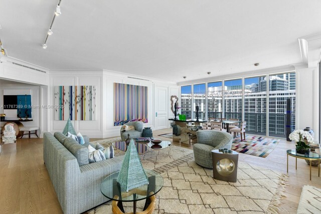 10225 Collins Ave Unit 901, Bal Harbour, FL 33154 - kitchen with white cabinets, appliances with stainless steel finishes, a sink, ornamental molding, and a warming drawer