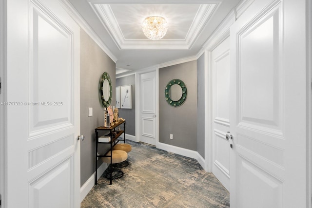 entrance foyer with baseboards, ornamental molding, and a chandelier