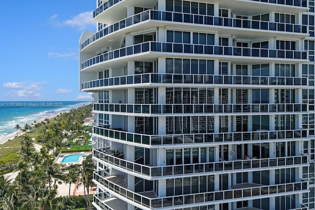 view of property with a beach view and a water view