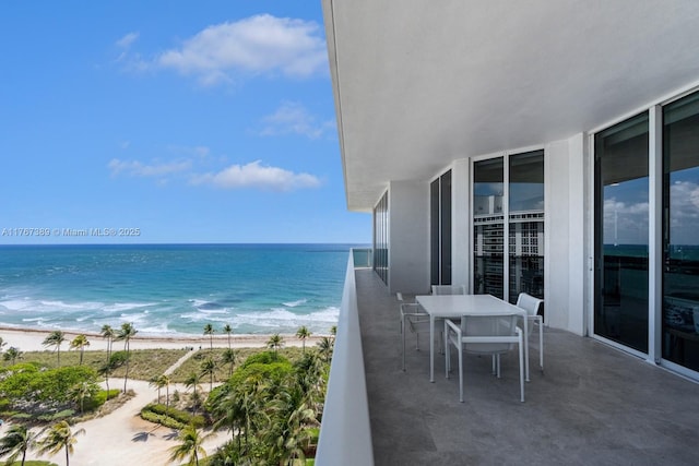 balcony with a beach view and a water view
