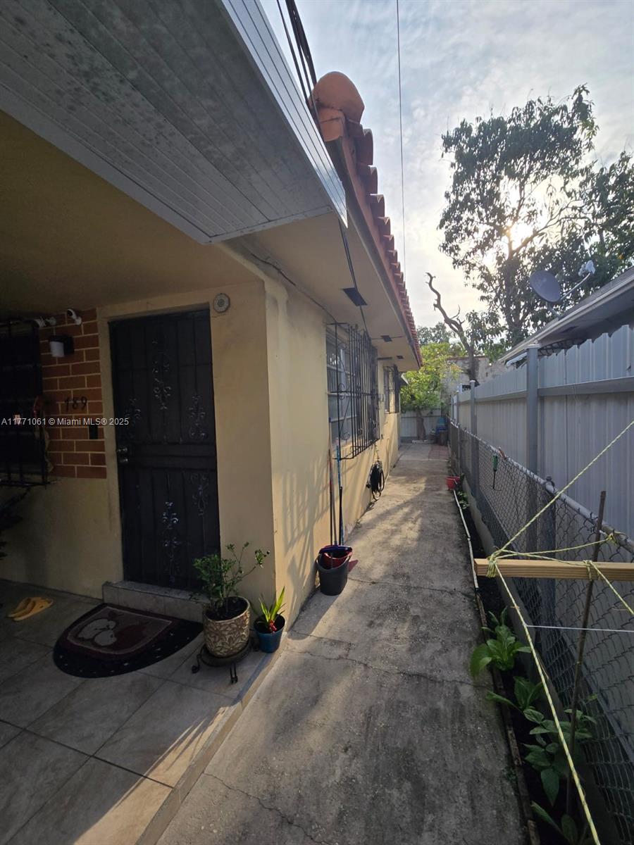 791 NW 22nd Pl, Miami, FL 33125 - exterior space featuring stucco siding and fence