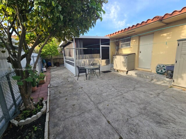 791 NW 22nd Pl, Miami, FL 33125 - view of patio / terrace featuring a sunroom and a fenced backyard