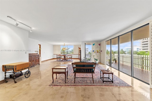 1 Grove Isle Dr Unit A409, Miami, FL 33133 - living room with baseboards and a chandelier