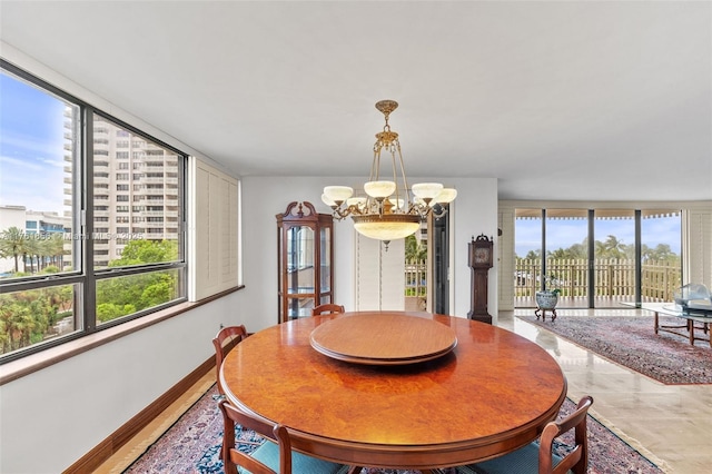 1 Grove Isle Dr Unit A409, Miami, FL 33133 - dining area with a chandelier and baseboards